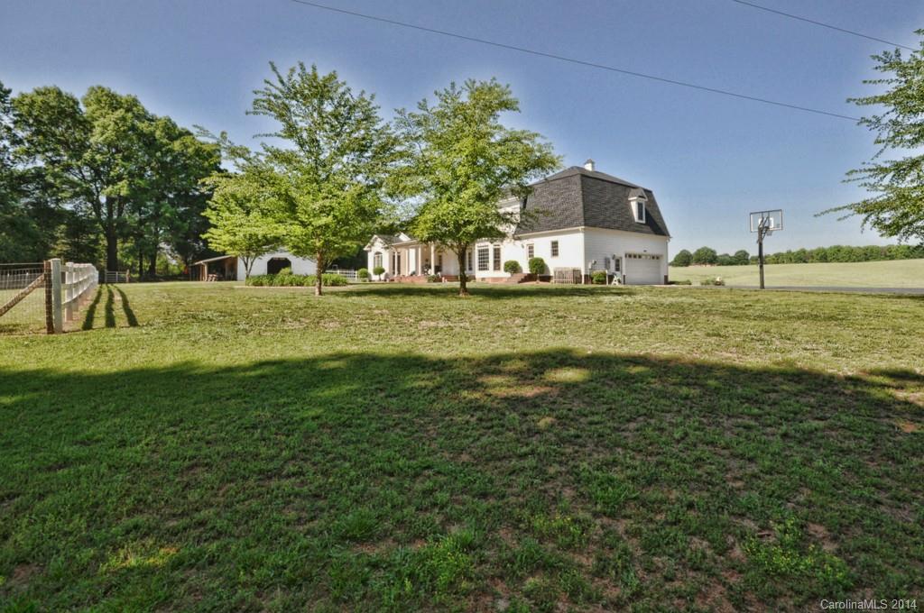 5406 Morgan Mill Road, Unit 2 Monroe, NC 28110 - Photo 17 of 23 a view of a house with a big yard