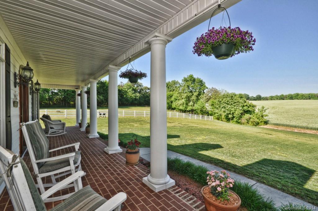 5406 Morgan Mill Road, Unit 2 Monroe, NC 28110 - Photo 3 of 23 a view of a patio with lawn chairs under an umbrella