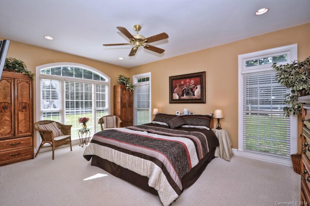 5406 Morgan Mill Road, Unit 2 Monroe, NC 28110 - Photo 9 of 23 a bedroom with a bed a couch and a large window