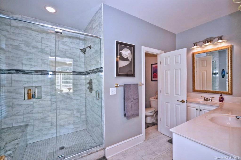 5406 Morgan Mill Road, Unit 2 Monroe, NC 28110 - Photo 10 of 23 a bathroom with a shower sink and mirror