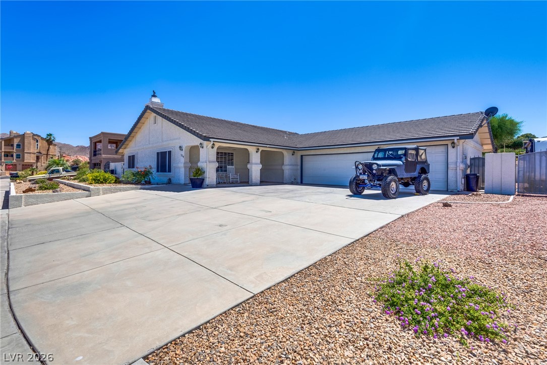 524 Swallow Cove Boulder City, NV 89005 - Photo 4 of 58 A spacious driveway and charming covered porch introduce this inviting residence.