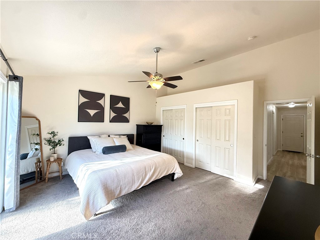 2709 Big Sandy Avenue Merced, CA 95348 - Photo 31 of 51 a bedroom with a large bed chandelier and a window