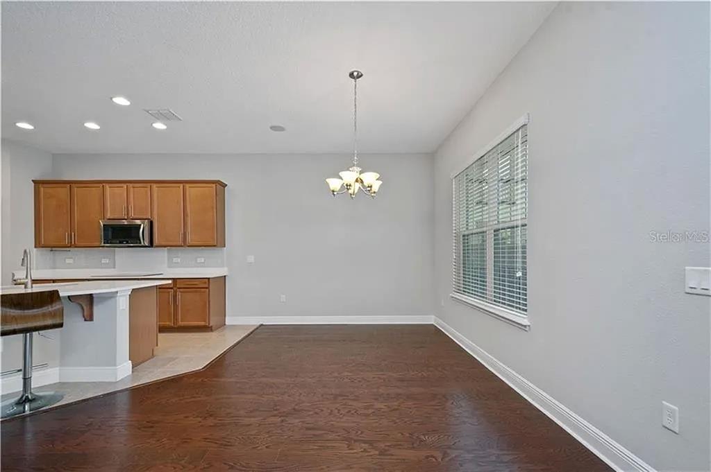 8752 Powder Ridge Trail Windermere, FL 34786 - Photo 13 of 31 a view of a kitchen with microwave and furniture