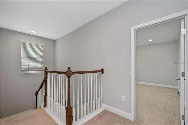 a view of a hallway with windows