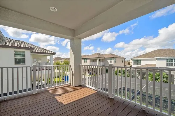 a view of a house with a wooden deck