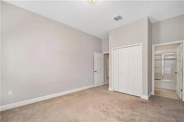 an empty room with closet area