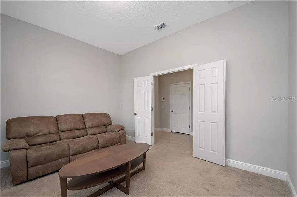 8752 Powder Ridge Trail Windermere, FL 34786 - Photo 9 of 31 a living room with furniture a couch and dryer
