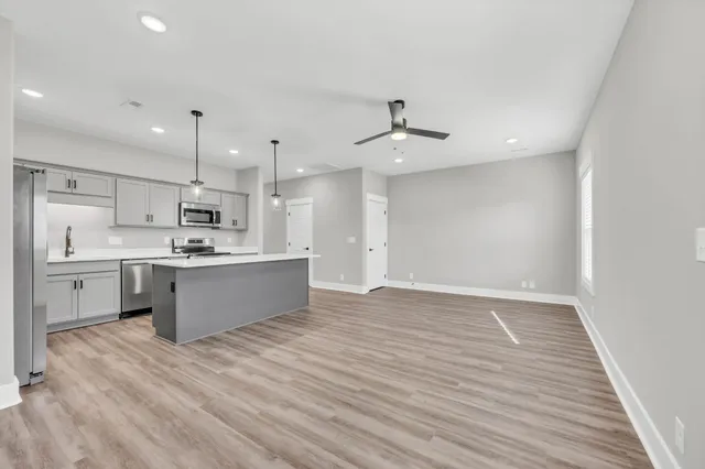 a large kitchen with a lot of counter space and stainless steel appliances