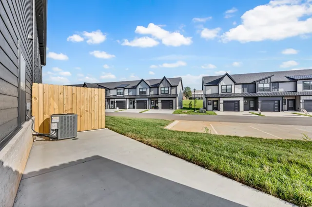 a front view of a house with a garden and yard