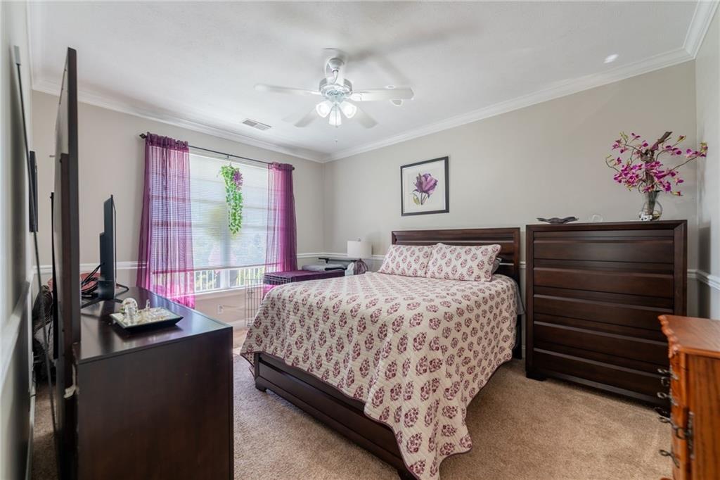 219 Adams Pointe Boulevard, Unit 9 Mars, PA 16046 - Photo 11 of 26 Primary bedroom with crown molding, a lighted ceiling fan, a large window, double closets that lead back to primary bath