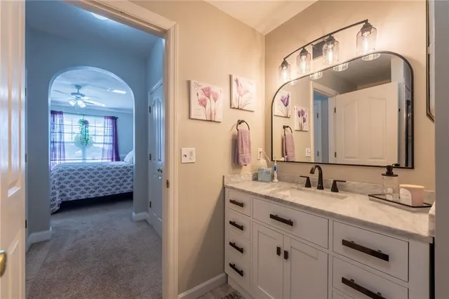a en suite bathroom with a sink double vanity and a mirror