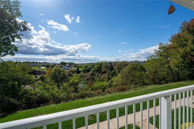 a view of a city with lush green forest