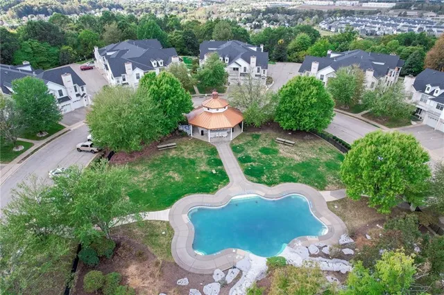 an aerial view of a house with garden space and street view