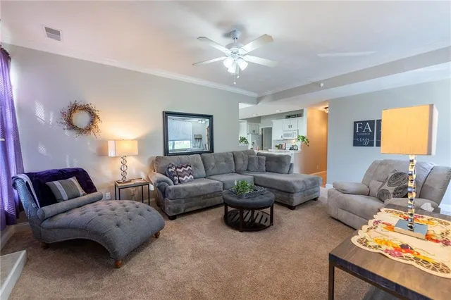 a living room with furniture and a chandelier