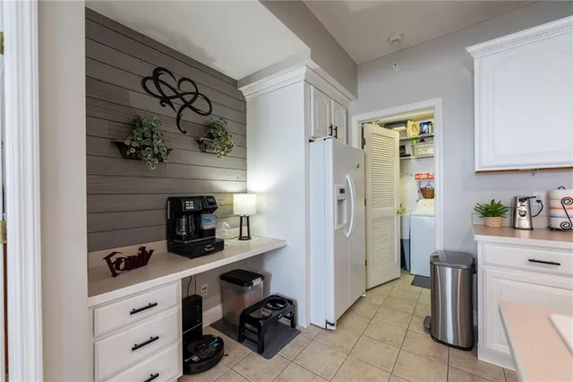 a kitchen with a refrigerator and cabinets