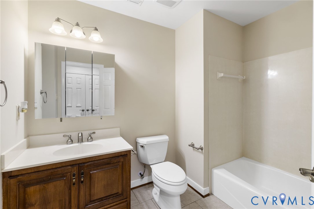 104 Petersburg Road Powhatan, VA 23139 - Photo 22 of 45 a bathroom with a granite countertop sink toilet and shower