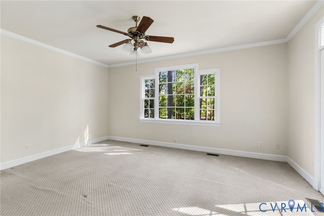 104 Petersburg Road Powhatan, VA 23139 - Photo 28 of 45 an empty room with a ceiling fan and windows