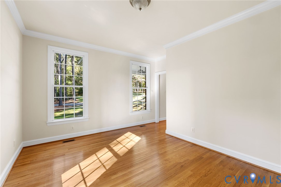 104 Petersburg Road Powhatan, VA 23139 - Photo 6 of 45 an empty room with wooden floor and windows