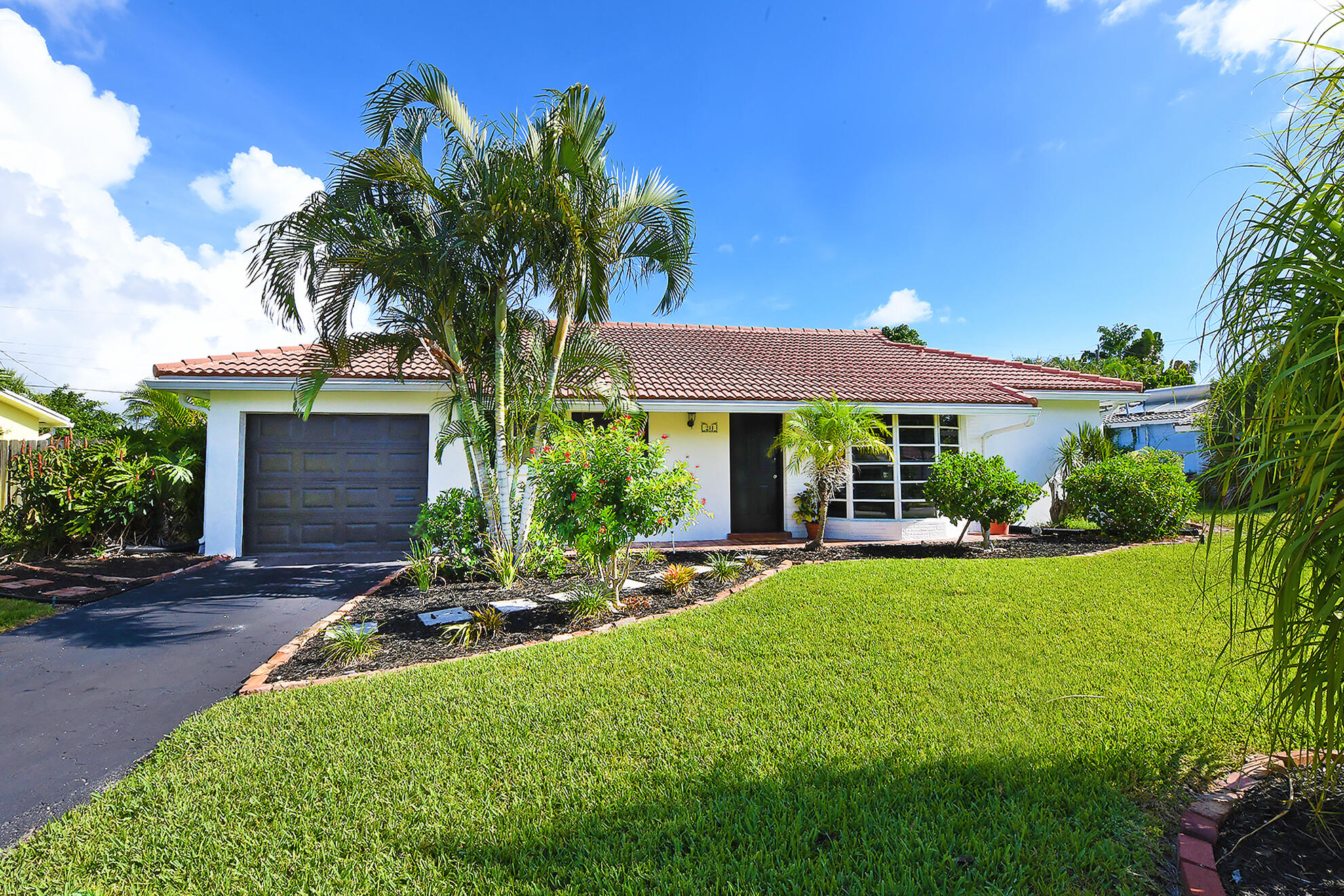 a front view of house with yard and outdoor seating