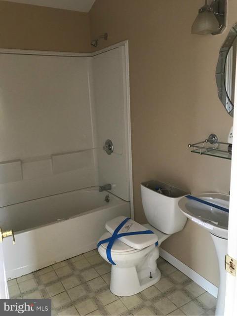 8149 Elizabeth Road Pasadena, MD 21122 - Photo 9 of 18 a white toilet sitting next to a bath tub