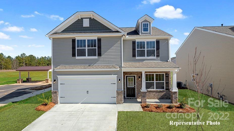 7588 Stonehouse Drive Gastonia, NC 28056 - Photo 1 of 20 a front view of a house with garden