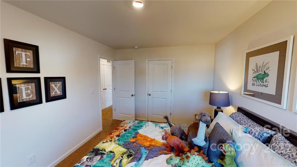 7588 Stonehouse Drive Gastonia, NC 28056 - Photo 12 of 20 a bed room with a bed and a couch