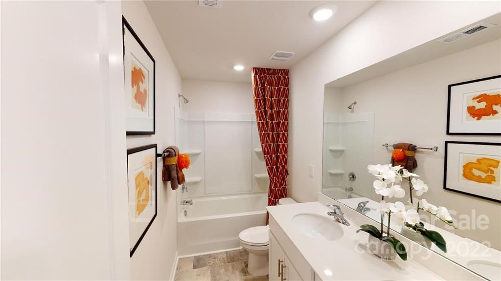 7588 Stonehouse Drive Gastonia, NC 28056 - Photo 13 of 20 a bathroom with a sink toilet and shower