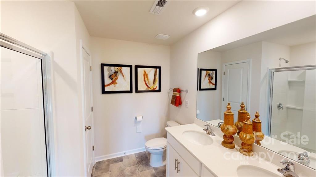 7588 Stonehouse Drive Gastonia, NC 28056 - Photo 18 of 20 a bathroom with a sink vanity mirror and toilet