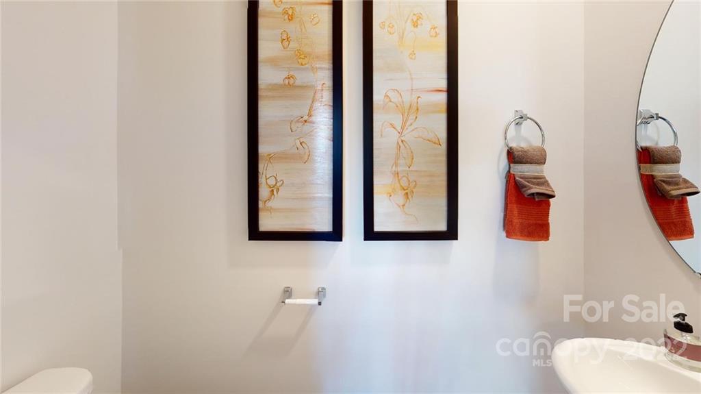 7588 Stonehouse Drive Gastonia, NC 28056 - Photo 19 of 20 a bathroom with a toilet sink and mirror