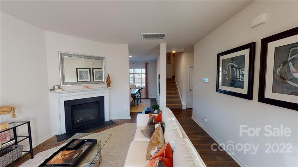 7588 Stonehouse Drive Gastonia, NC 28056 - Photo 2 of 20 a living room with furniture and a fireplace