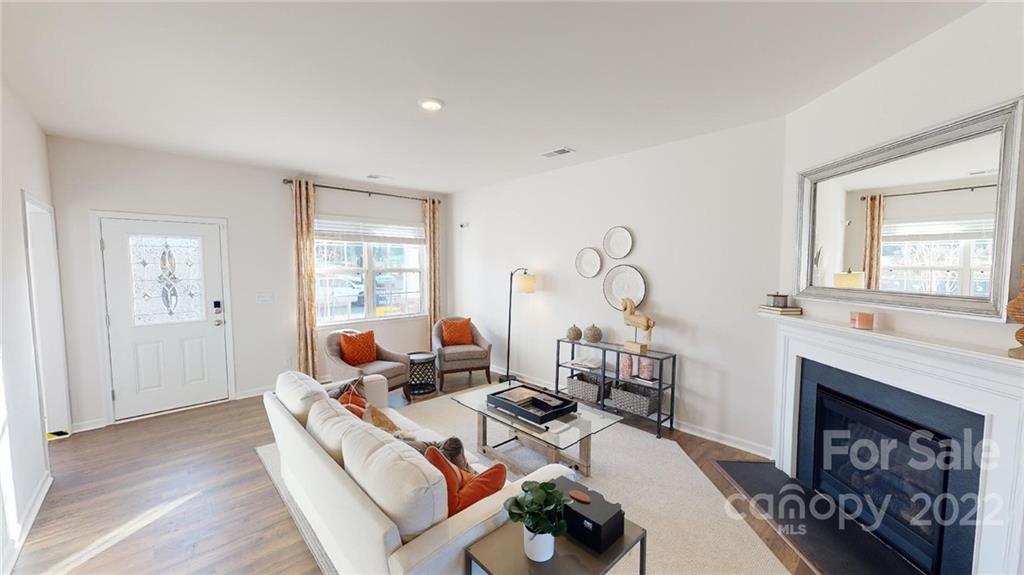 7588 Stonehouse Drive Gastonia, NC 28056 - Photo 4 of 20 a living room with furniture a fireplace and a window