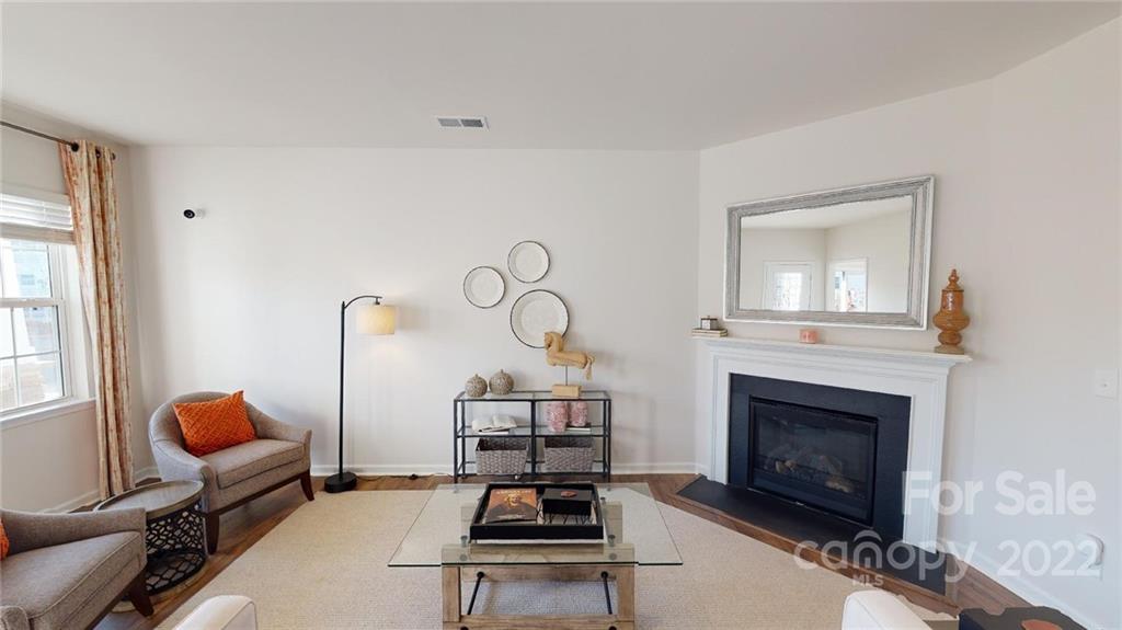 7588 Stonehouse Drive Gastonia, NC 28056 - Photo 5 of 20 a living room with furniture a fireplace and a window