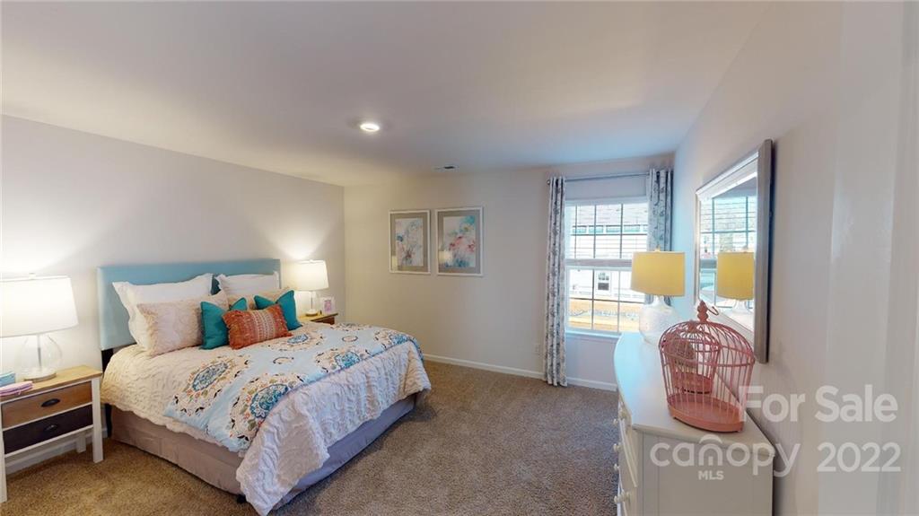 7588 Stonehouse Drive Gastonia, NC 28056 - Photo 10 of 20 a bedroom with a bed and walk in closet