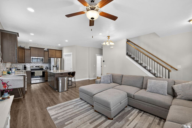 412 McClellan Court Provo, UT 84601 - Photo 6 of 20 Living room featuring wood finished floors, a ceiling fan, and a chandelier