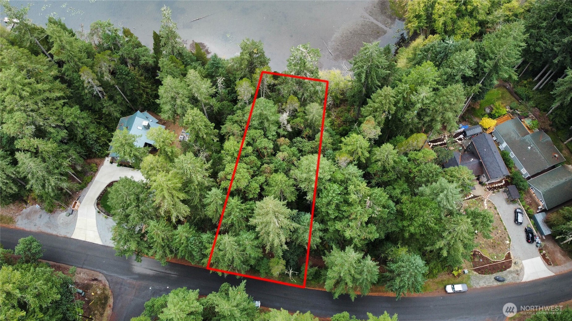11026 Matthews Way Anderson Island, WA 98303 - Photo 2 of 4 an aerial view of a house with a yard basket ball court and outdoor seating