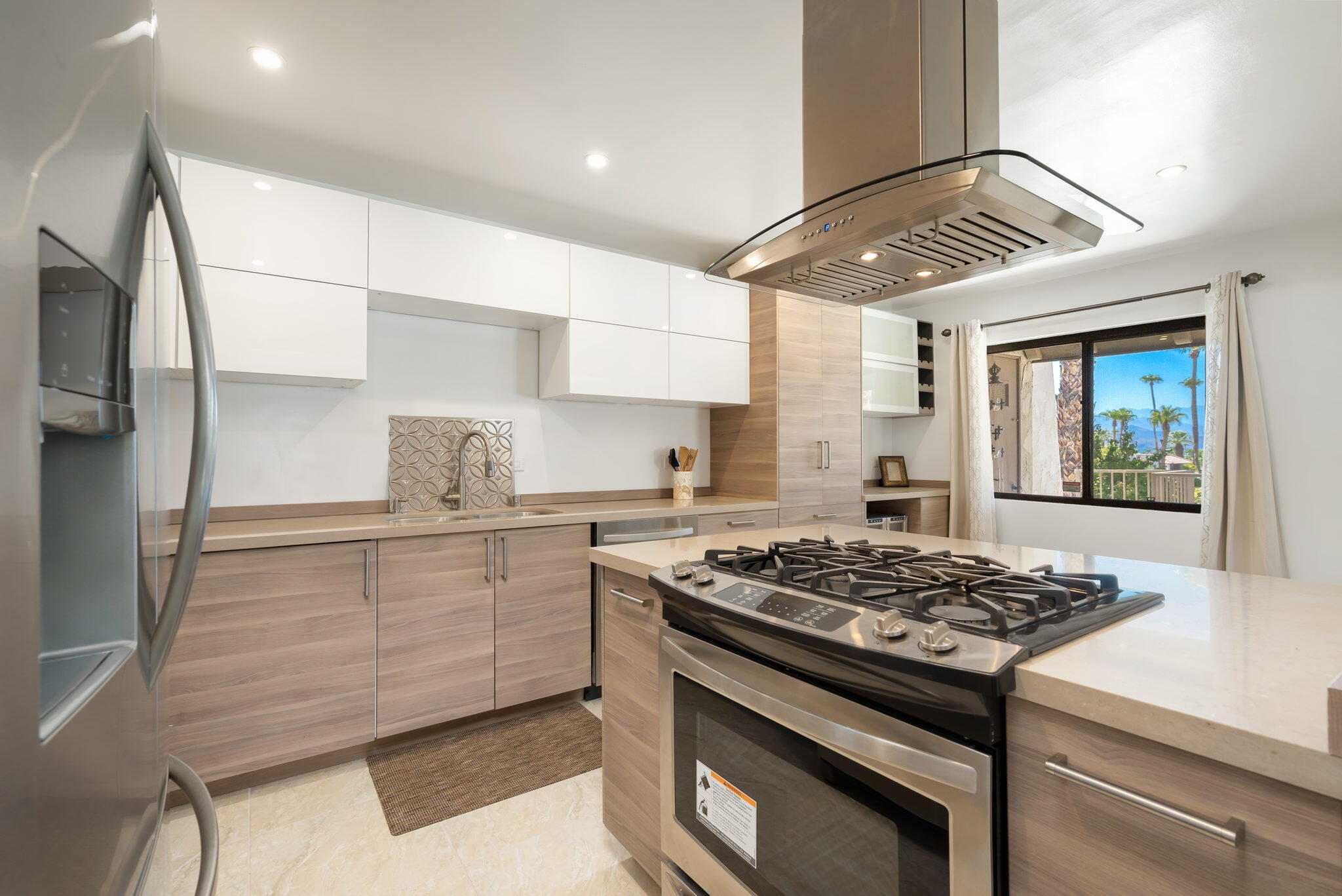 349 West Mariscal Road Palm Springs, CA 92262 - Photo 22 of 34 a kitchen with stainless steel appliances a stove a sink and a refrigerator
