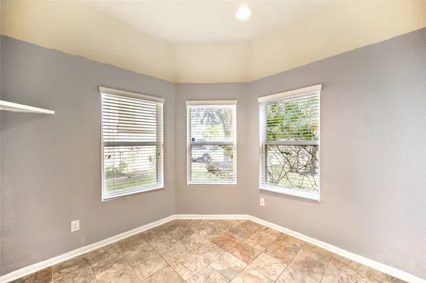 a view of an empty room with windows
