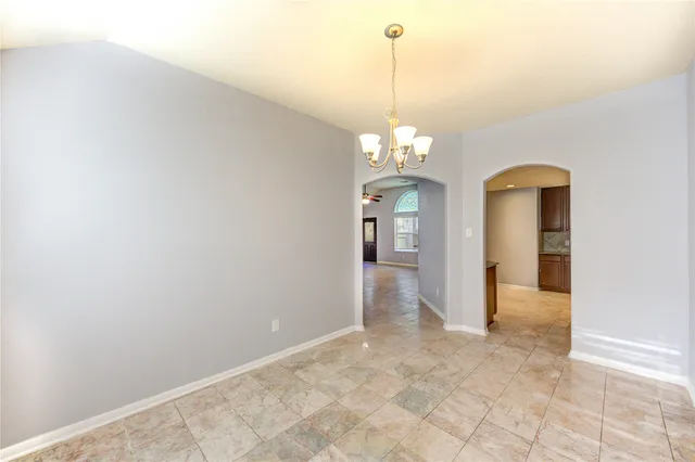a view of a hallway with a chandelier and chandelier