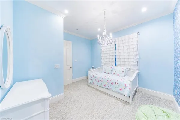 a bedroom with a bed and a chandelier