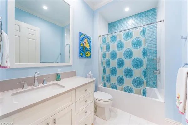 a bathroom with a sink mirror vanity and toilet