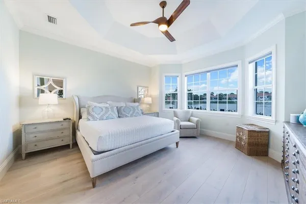 a bedroom with a bed and a large window