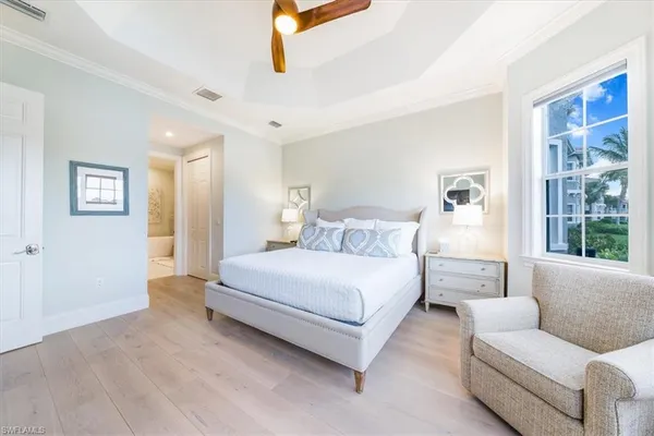 a spacious bedroom with a bed couch and a window