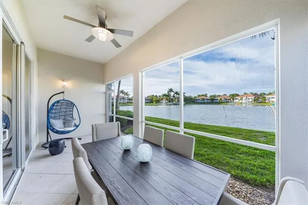 a living room with furniture and a floor to ceiling window