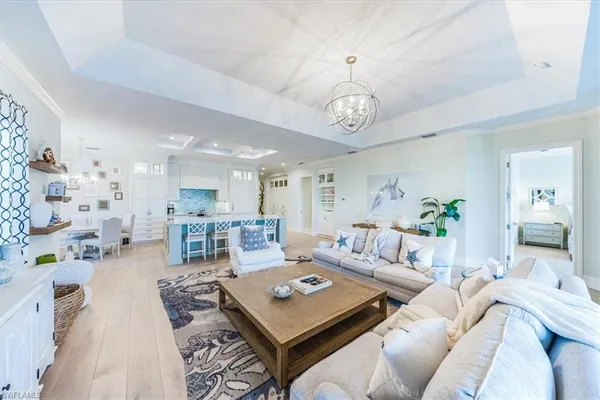 a living room with furniture or couches and a dining table with wooden floor