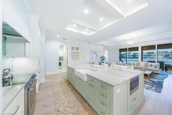 a large white kitchen with a large window