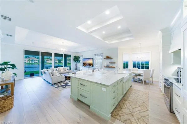 a living room with furniture large window and a table