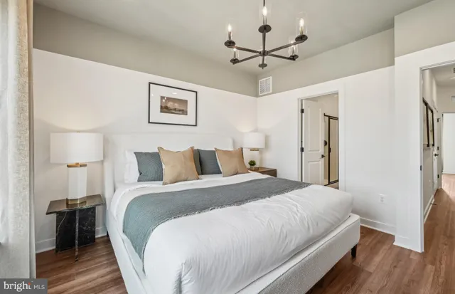 a bathroom with a toilet a sink a mirror and a window