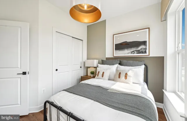 a bedroom with a bed and a painting on the wall