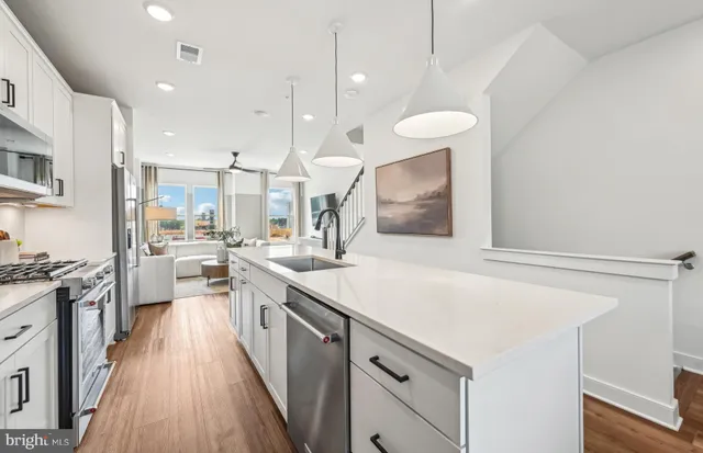 a large kitchen with a table and chairs