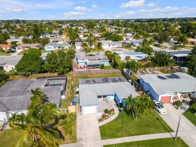 an aerial view of residential houses with outdoor space